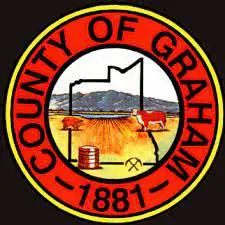 A red and yellow county seal with a picture of a cow.