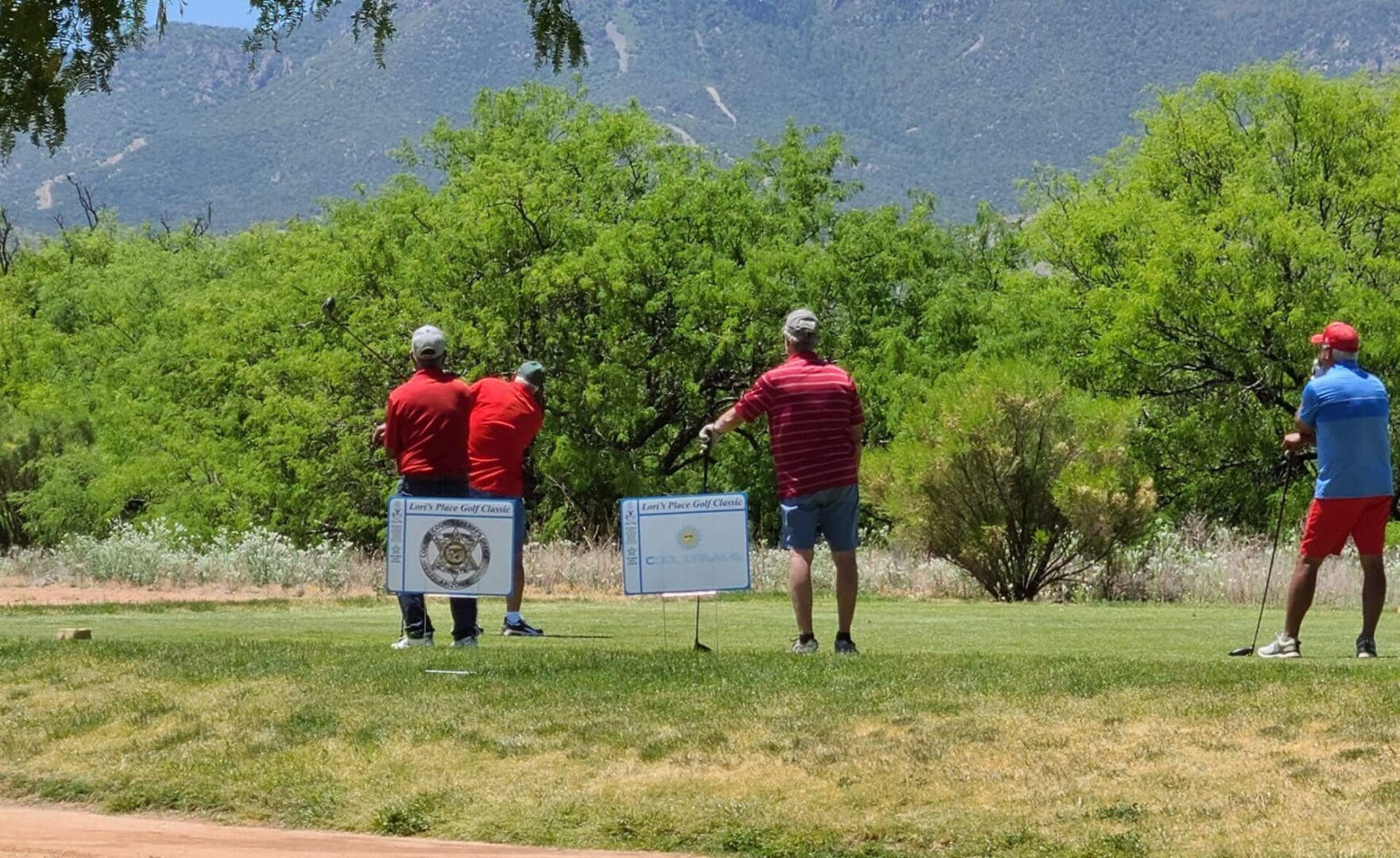 Three men are playing golf on a green.