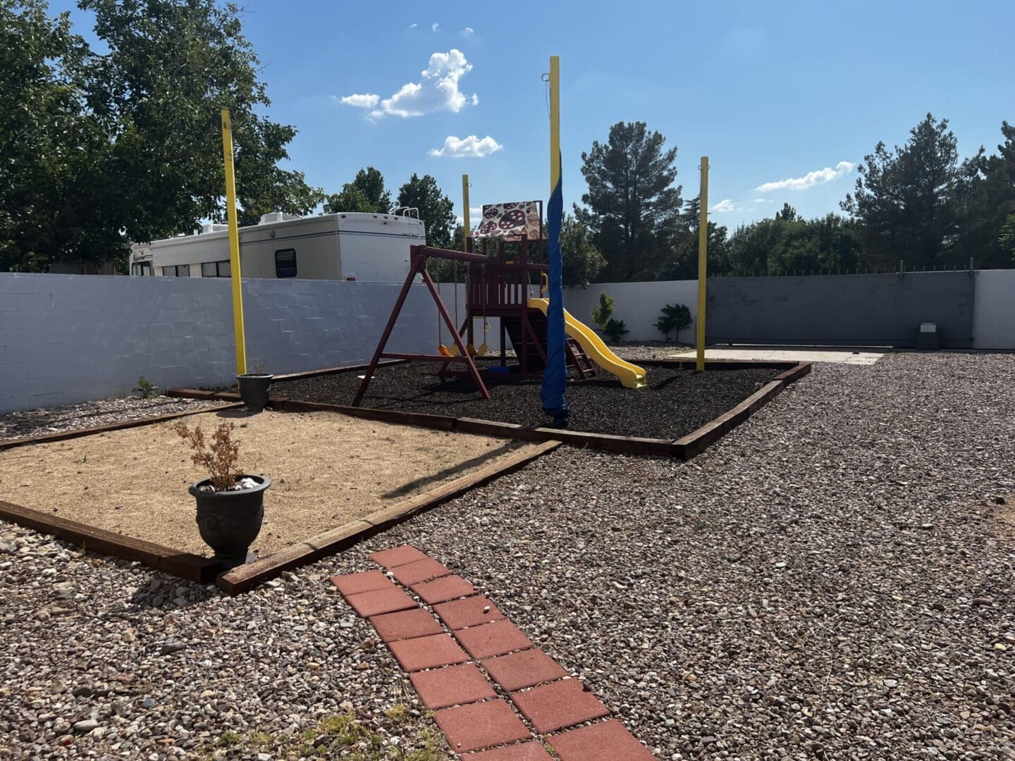 A playground with swings and slides in the yard.